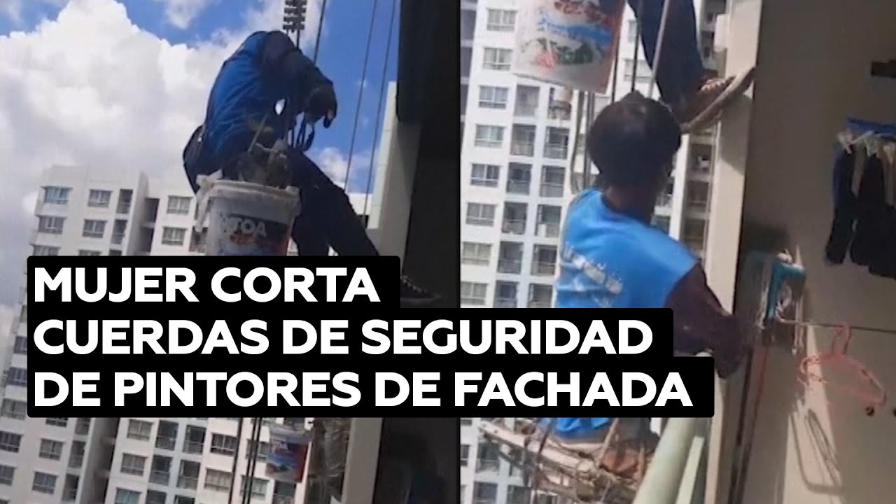 Mujer corta las cuerdas de seguridad de unos pintores de fachada @RT Play en Español
