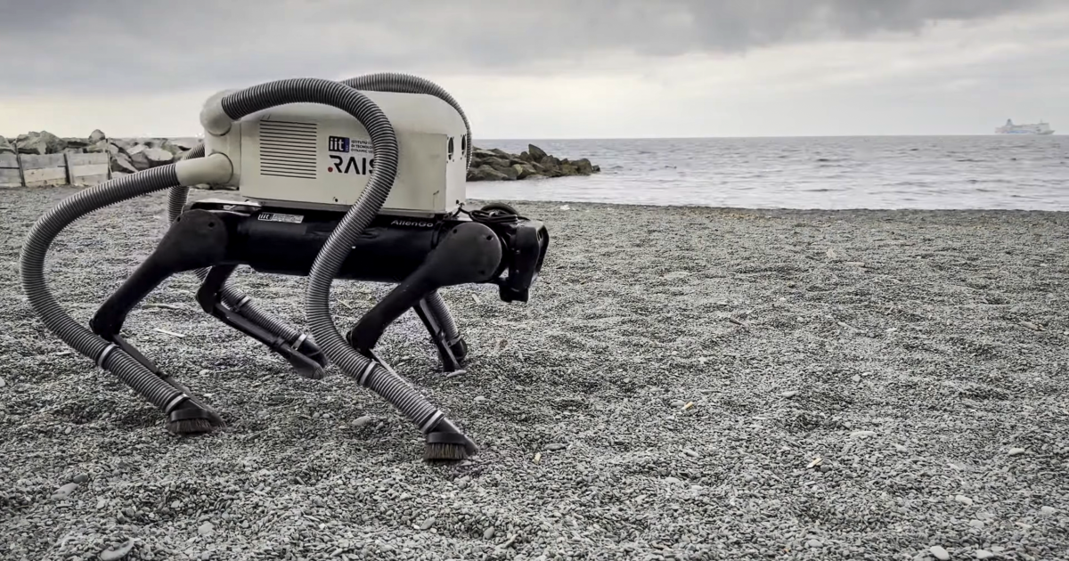 Un perro robot con patas aspiradoras limpia la playa