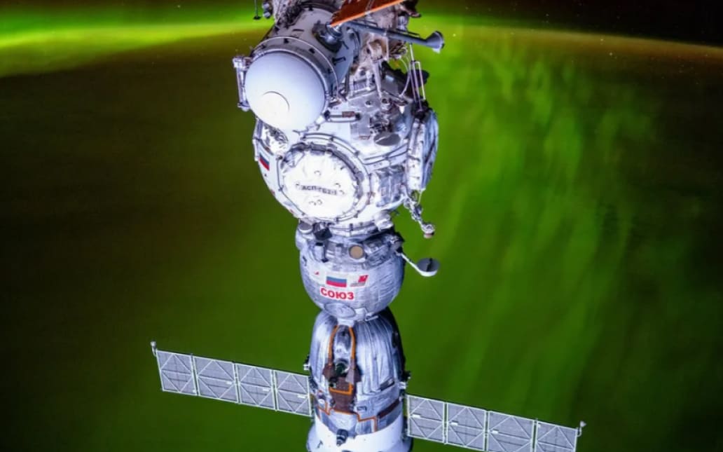 Astronauta de la NASA capta una impresionante aurora verde detrás de la nave espacial rusa Soyuz acoplada a la ISS